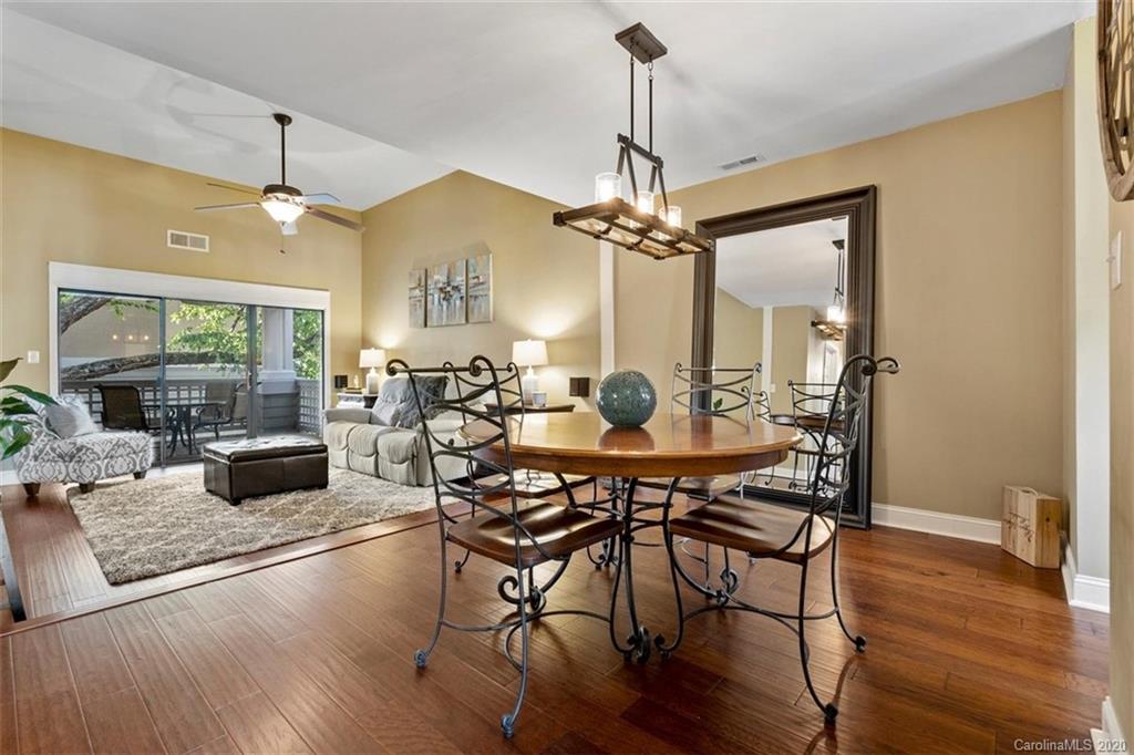 232 Queens Road, Unit 39 Charlotte, NC 28204 - Photo 13 of 29 a view of a dining room with furniture window and wooden floor