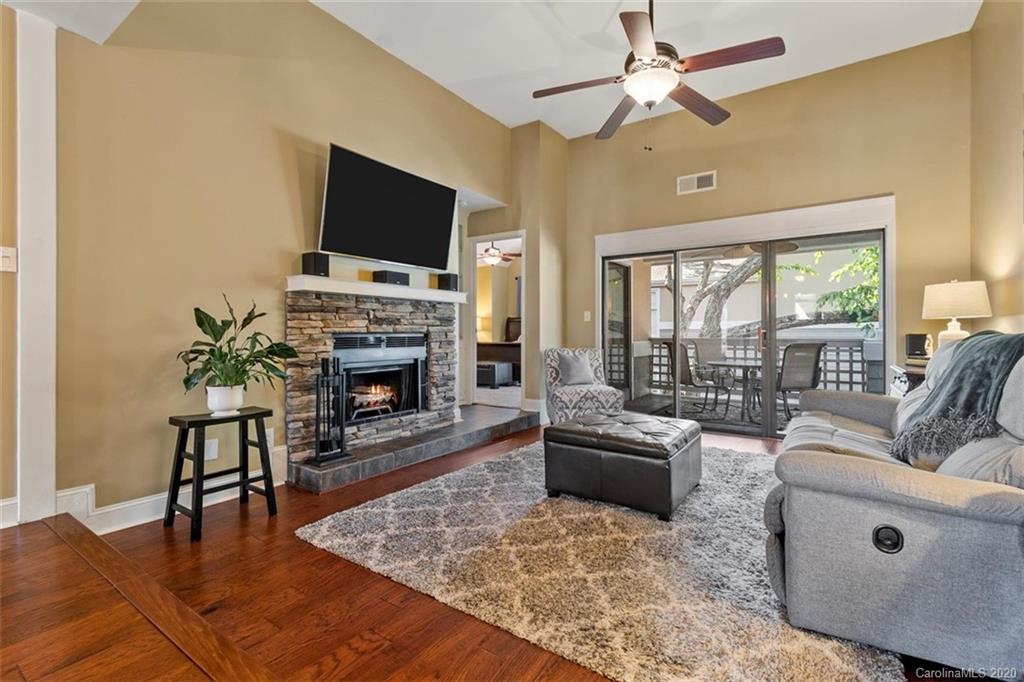 232 Queens Road, Unit 39 Charlotte, NC 28204 - Photo 16 of 29 a living room with furniture fireplace and a flat screen tv