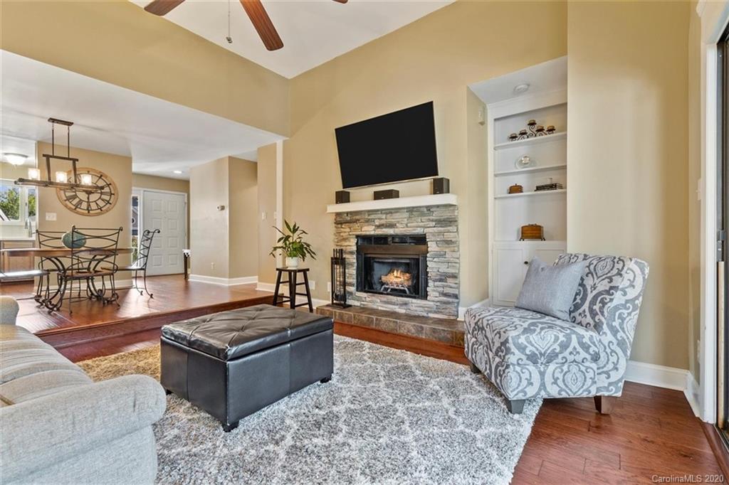 232 Queens Road, Unit 39 Charlotte, NC 28204 - Photo 17 of 29 a living room with furniture a flat screen tv and a fireplace