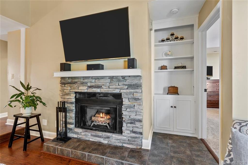 232 Queens Road, Unit 39 Charlotte, NC 28204 - Photo 18 of 29 a living room with a fireplace and a flat screen tv
