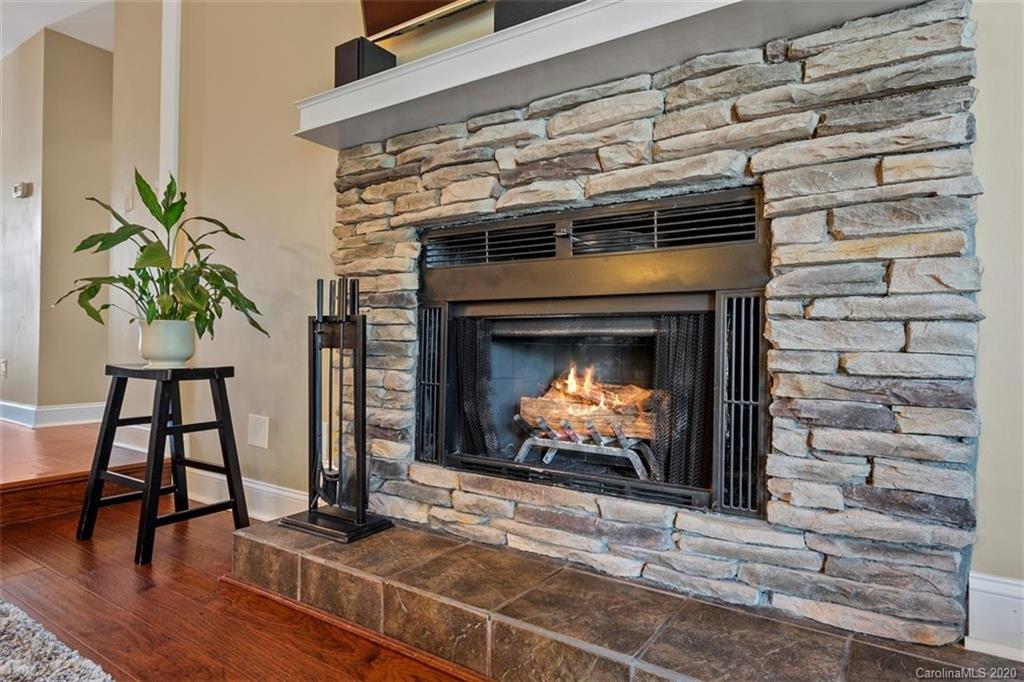 232 Queens Road, Unit 39 Charlotte, NC 28204 - Photo 19 of 29 a fireplace with a clock on wall