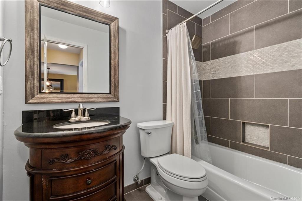 232 Queens Road, Unit 39 Charlotte, NC 28204 - Photo 21 of 29 a bathroom with a toilet a sink and a mirror
