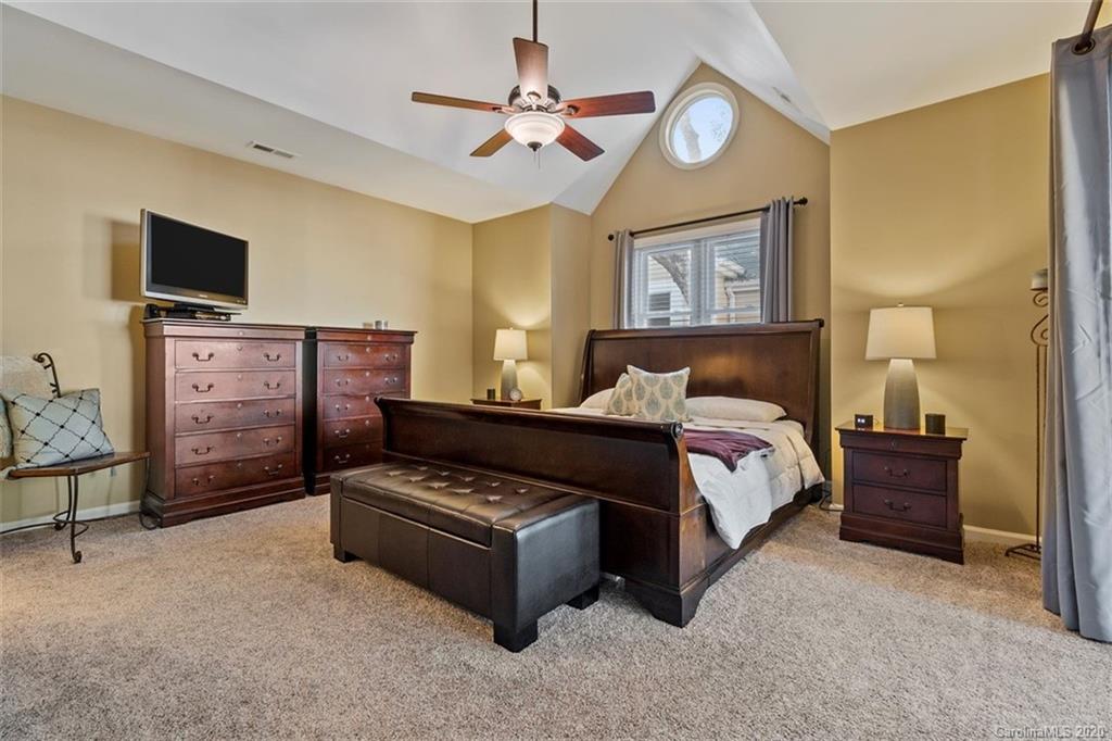 232 Queens Road, Unit 39 Charlotte, NC 28204 - Photo 22 of 29 a bedroom with a bed and a chandelier