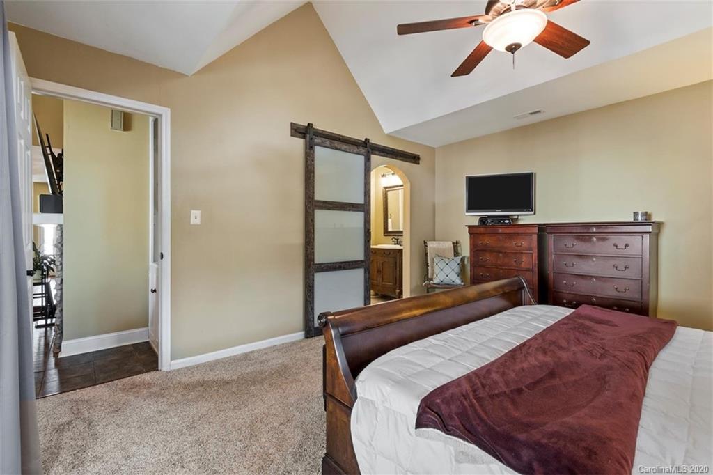232 Queens Road, Unit 39 Charlotte, NC 28204 - Photo 24 of 29 a bedroom with a bed and a flat screen tv