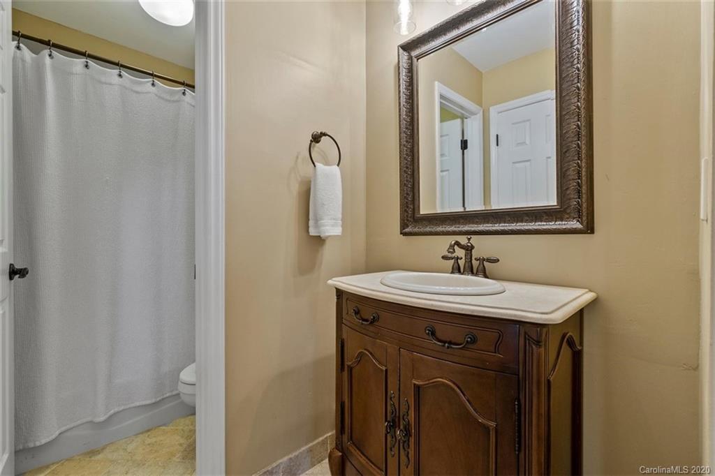 232 Queens Road, Unit 39 Charlotte, NC 28204 - Photo 26 of 29 a bathroom with a sink and a mirror