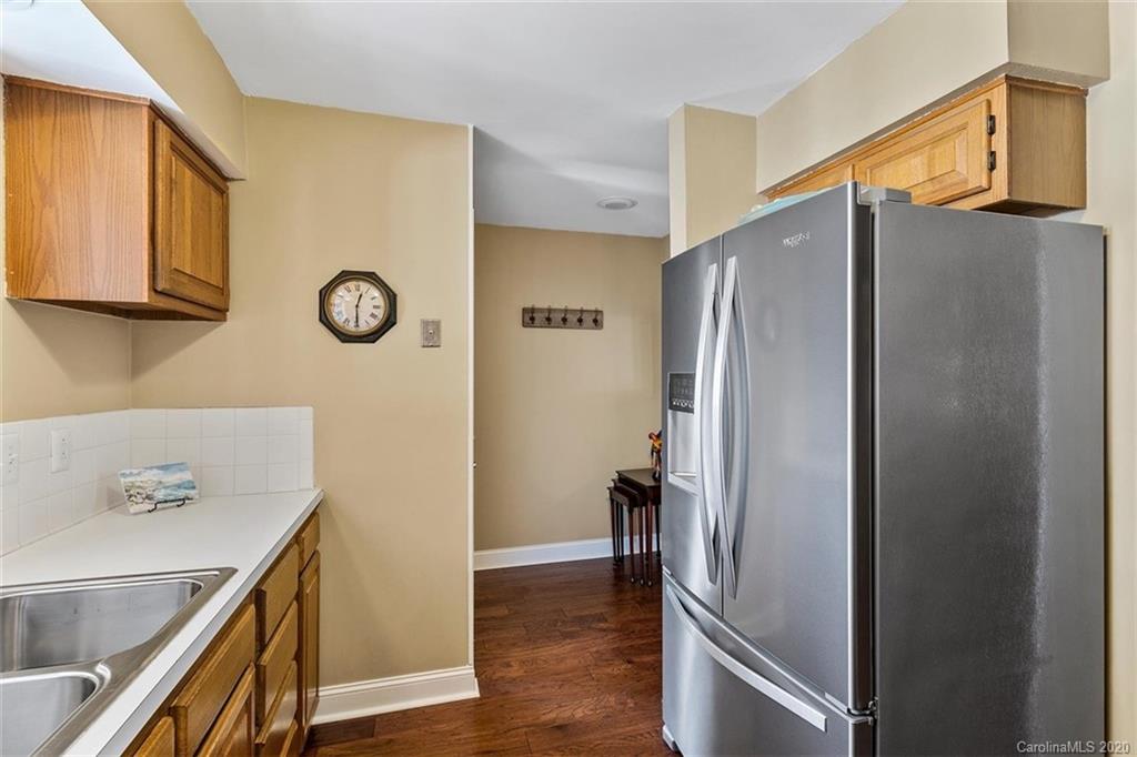 232 Queens Road, Unit 39 Charlotte, NC 28204 - Photo 10 of 29 a view of a refrigerator in kitchen and an empty room