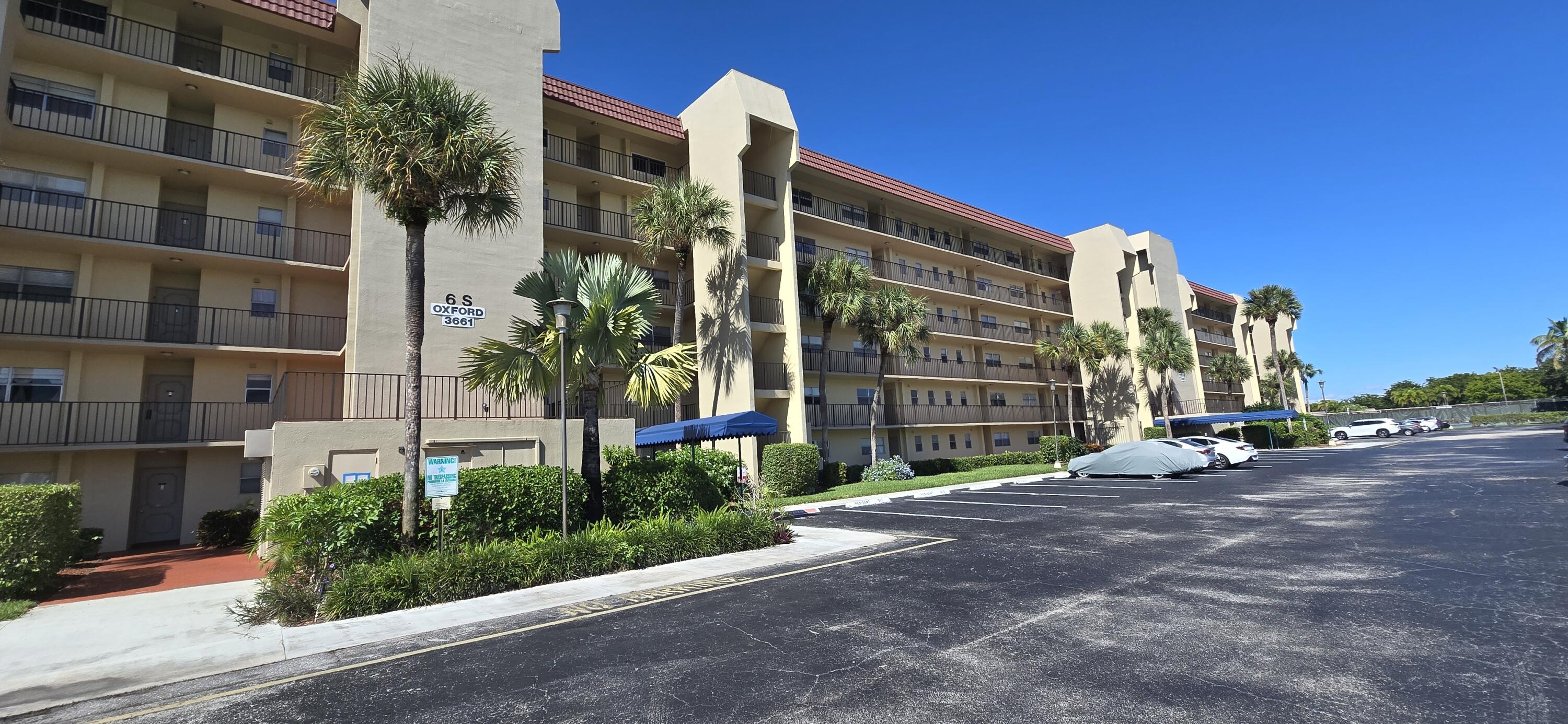 3661 Via Poinciana, Unit 306 Lake Worth, FL 33467 - Photo 1 of 13 a view of a building with a street