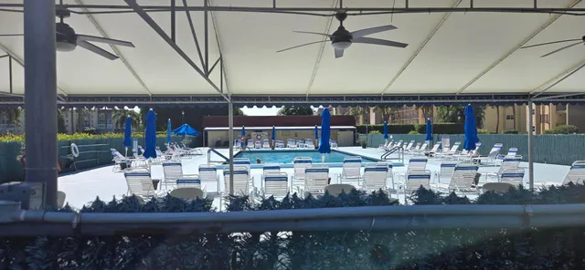 a view of a swimming pool with a table and chairs