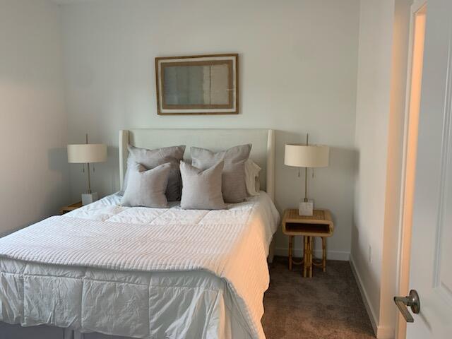 4290 Lakewood Road, Unit 101 Lake Worth, FL 33461 - Photo 11 of 13 a bedroom with a bed and a chair