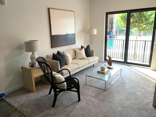 4290 Lakewood Road, Unit 101 Lake Worth, FL 33461 - Photo 3 of 13 a living room with furniture and a window
