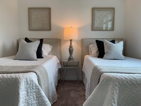 4290 Lakewood Road, Unit 101 Lake Worth, FL 33461 - Photo 4 of 13 a bedroom with two beds and a lamp on dresser