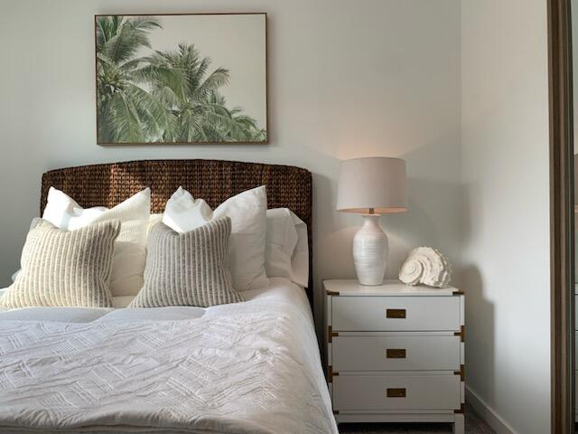 4290 Lakewood Road, Unit 101 Lake Worth, FL 33461 - Photo 8 of 13 a bedroom with a bed and painting on the wall