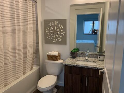 4290 Lakewood Road, Unit 101 Lake Worth, FL 33461 - Photo 9 of 13 a bathroom with a granite countertop toilet sink and mirror