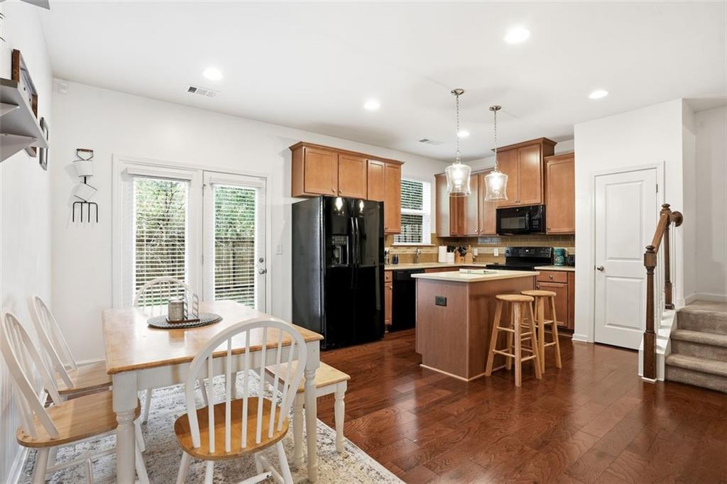 5026 Longview Walk Decatur, GA 30035 - Photo 6 of 31 a kitchen with refrigerator a dining table and chairs
