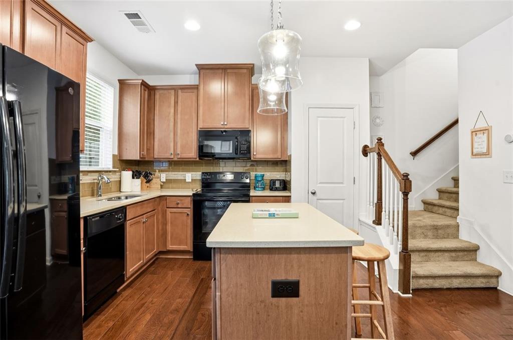 5026 Longview Walk Decatur, GA 30035 - Photo 7 of 31 a kitchen with stainless steel appliances a stove refrigerator sink and microwave