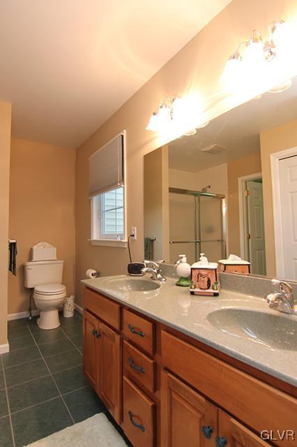 4144 Walter Road Bethlehem, PA 18020 - Photo 11 of 46 a bathroom with a granite countertop sink a toilet and mirror