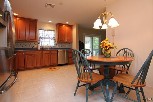4144 Walter Road Bethlehem, PA 18020 - Photo 27 of 46 a view of a dining room with furniture a chandelier and wooden floor