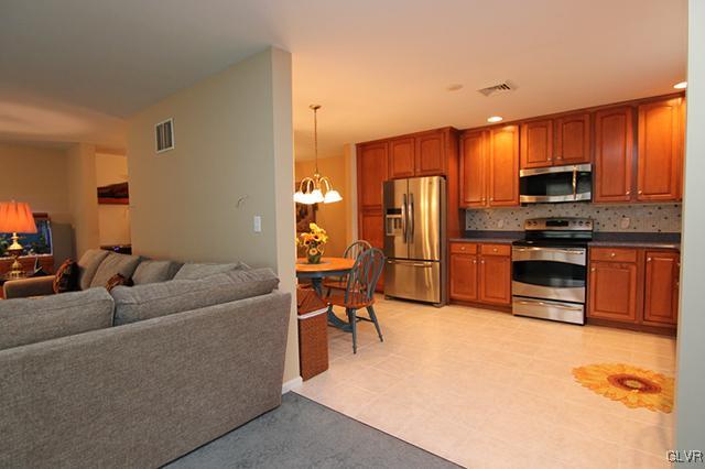 4144 Walter Road Bethlehem, PA 18020 - Photo 32 of 46 a living room with furniture a kitchen island with appliances and cabinets
