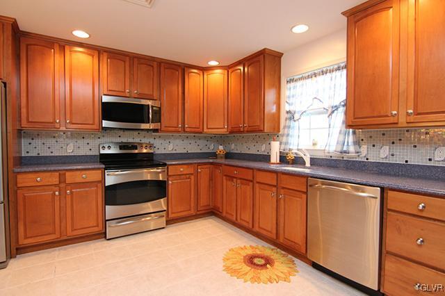 4144 Walter Road Bethlehem, PA 18020 - Photo 6 of 46 a kitchen with stainless steel appliances granite countertop a stove a sink dishwasher and a microwave oven with cabinets