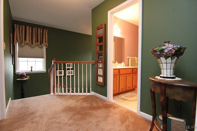 4144 Walter Road Bethlehem, PA 18020 - Photo 7 of 46 a bedroom with a bed and a chandelier