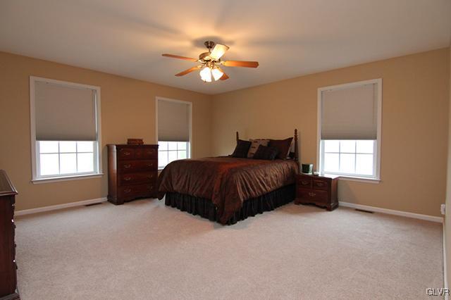 4144 Walter Road Bethlehem, PA 18020 - Photo 8 of 46 a bedroom with a bed and a chandelier