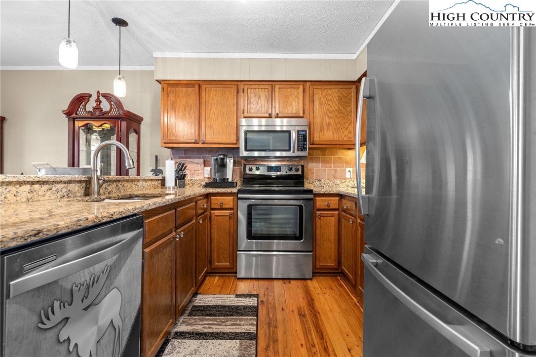 301 Pinnacle Inn Road, Unit 3219 Beech Mountain, NC 28604 - Photo 6 of 30 a kitchen with stainless steel appliances granite countertop a refrigerator and a sink