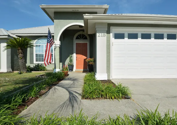 a front view of a house with a yard