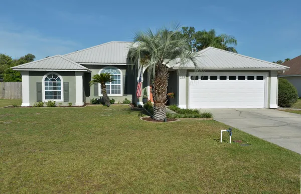 a kitchen with stainless steel appliances kitchen island granite countertop a refrigerator and a stove top oven