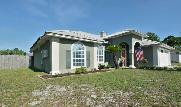 a kitchen with stainless steel appliances granite countertop white cabinets a sink and a stove