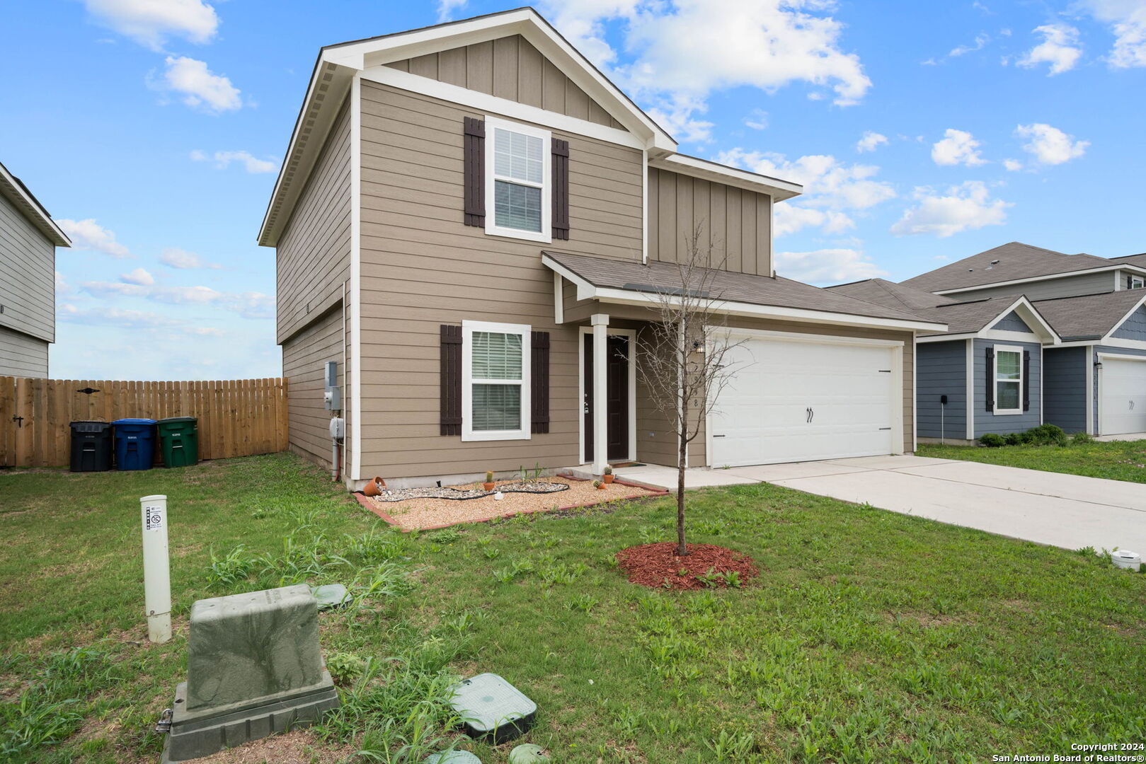 a front view of a house with a yard and garage