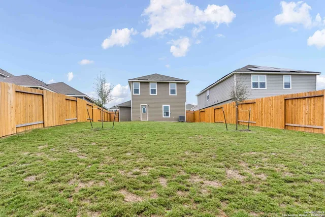 a front view of a house with a big yard