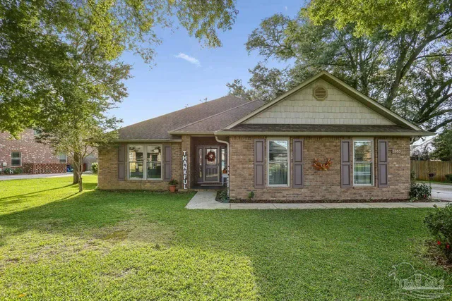 a front view of a house with a garden and yard