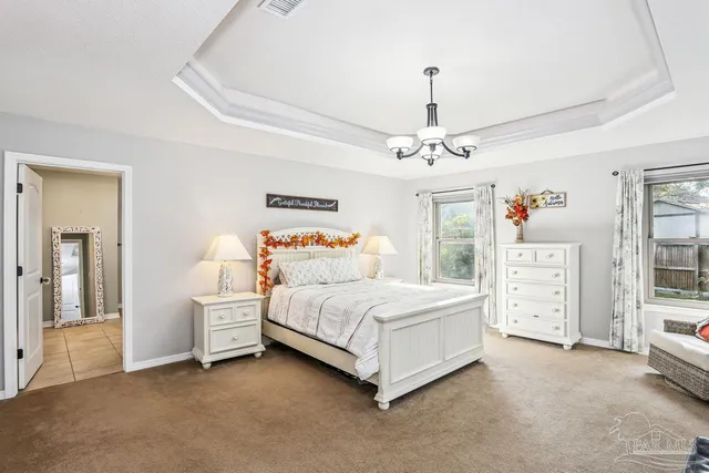 a spacious bedroom with a bed and a window