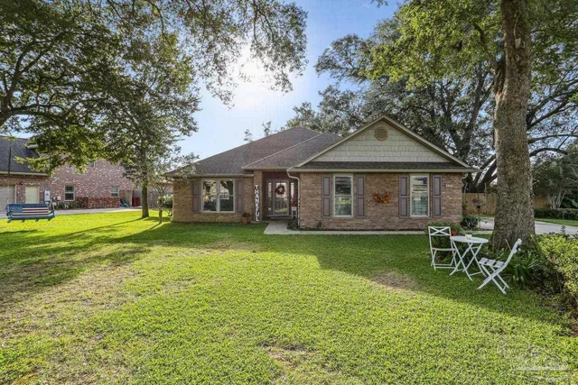 a front view of a house with a garden