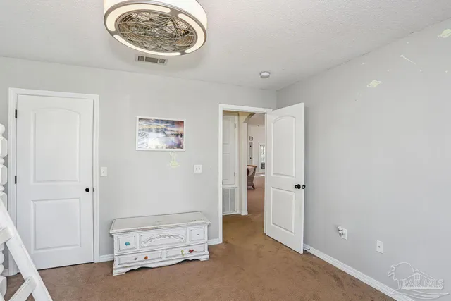a bathroom with shower a mirror and a sink