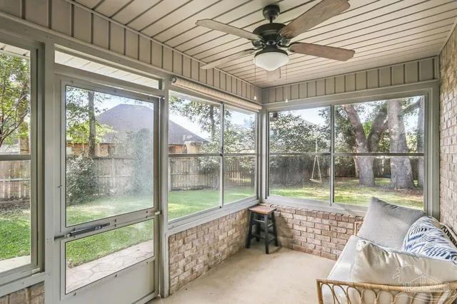 a view of a backyard with table and chairs and a large tree