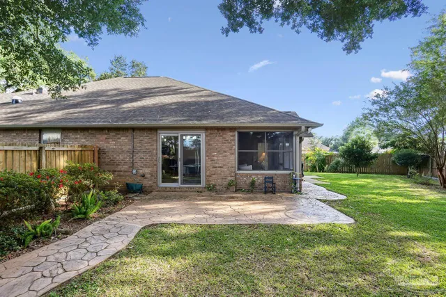 a view of a house with a backyard