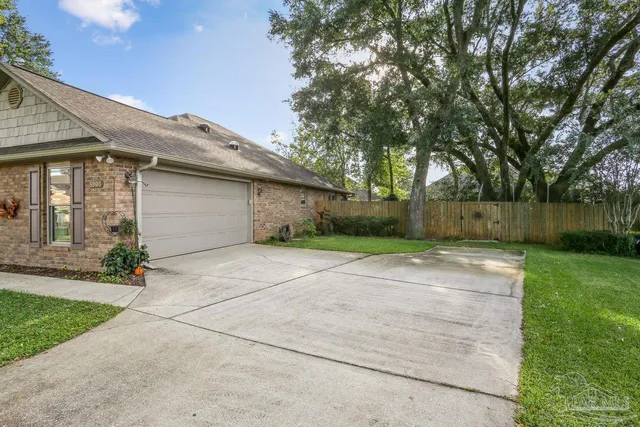 a view of backyard of house and car parked