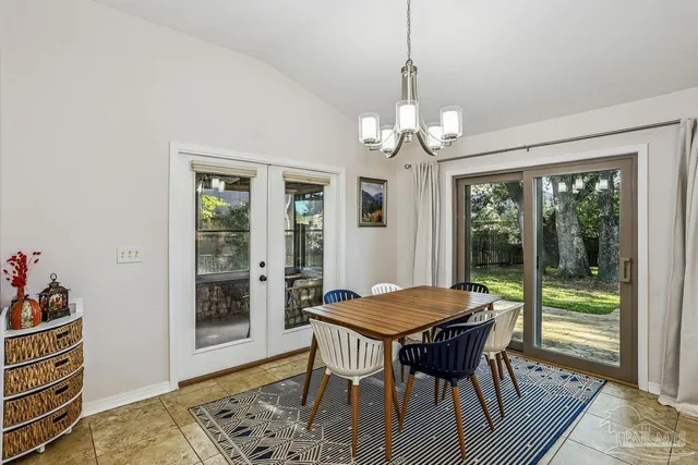 a view of a dining room with furniture wooden floor and a chandelier