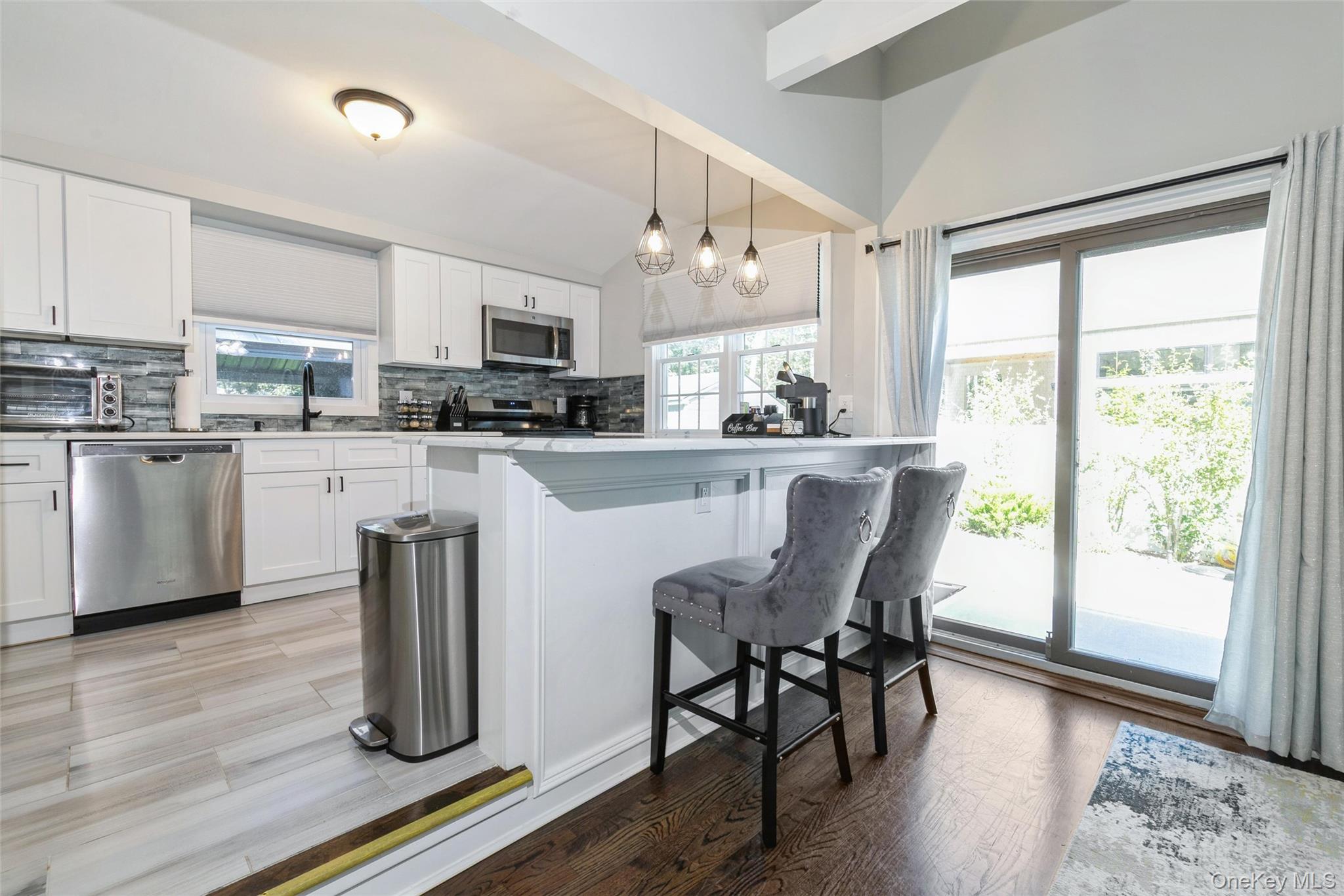 10 Rutland Road East Hampton, NY 11937 - Photo 12 of 47 a kitchen with kitchen island a dining table chairs and wooden floor