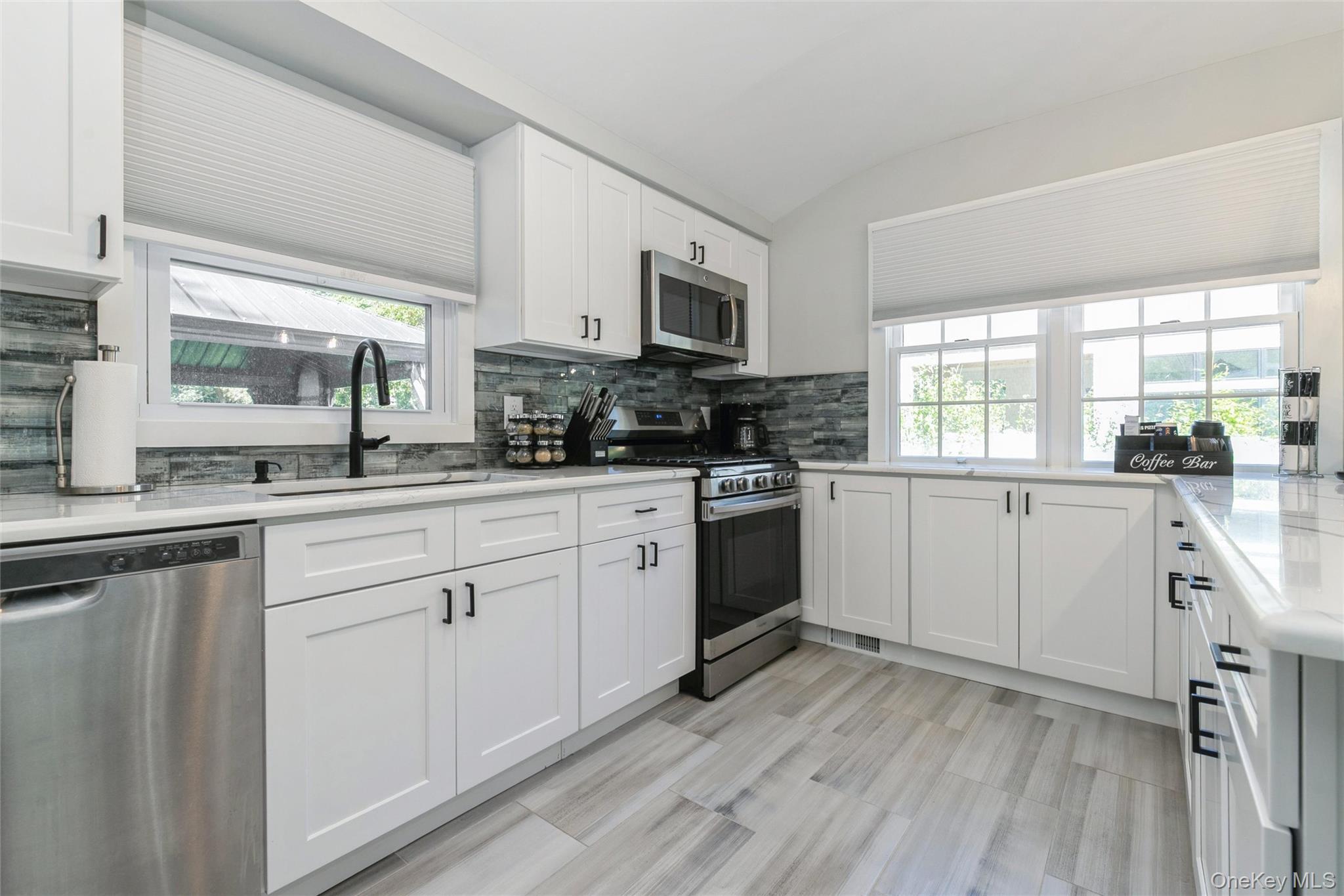 10 Rutland Road East Hampton, NY 11937 - Photo 13 of 47 a kitchen with white cabinets sink and appliances