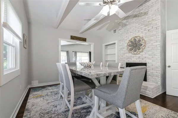 a dining room with furniture a rug and a chandelier