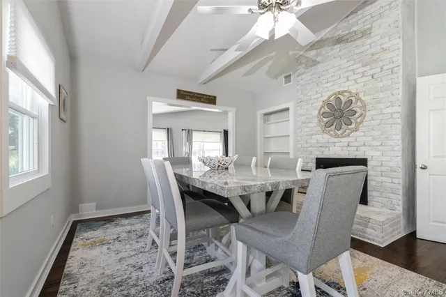 a dining room with furniture a rug and a chandelier