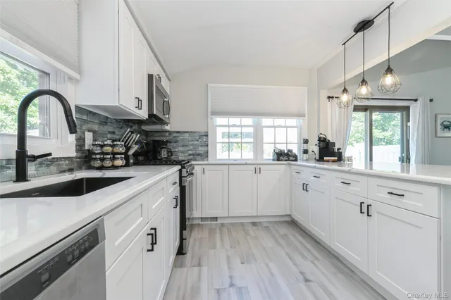 a kitchen with granite countertop white cabinets and white appliances