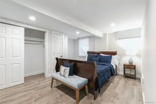 a bedroom with furniture and a wooden floor