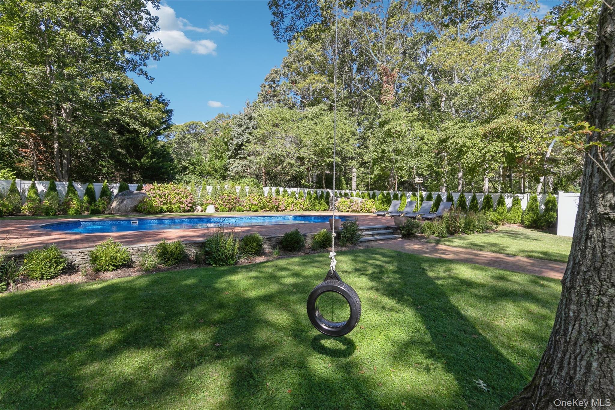 10 Rutland Road East Hampton, NY 11937 - Photo 26 of 47 a view of yard with swimming pool and trees