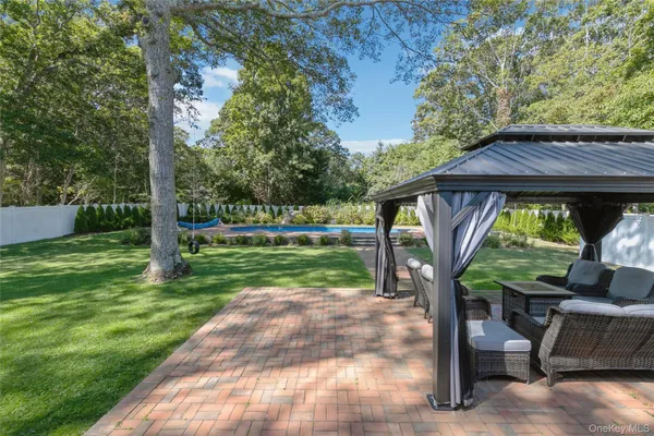 a view of a house with backyard and a sitting area