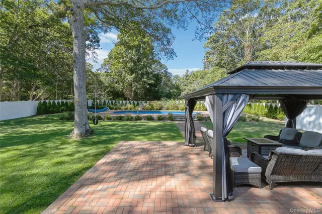 a view of a house with backyard and a sitting area