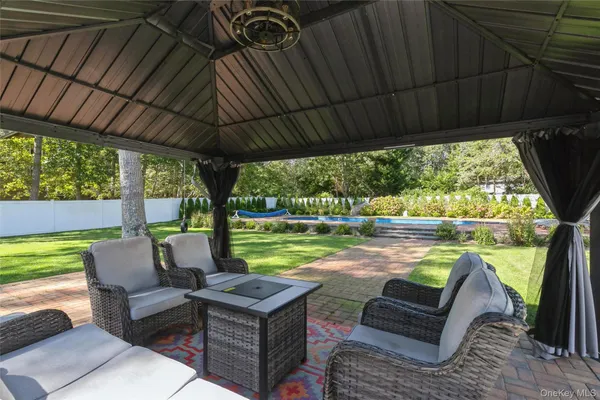 a view of house with backyard and outdoor seating