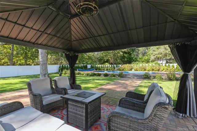 a view of house with backyard and outdoor seating